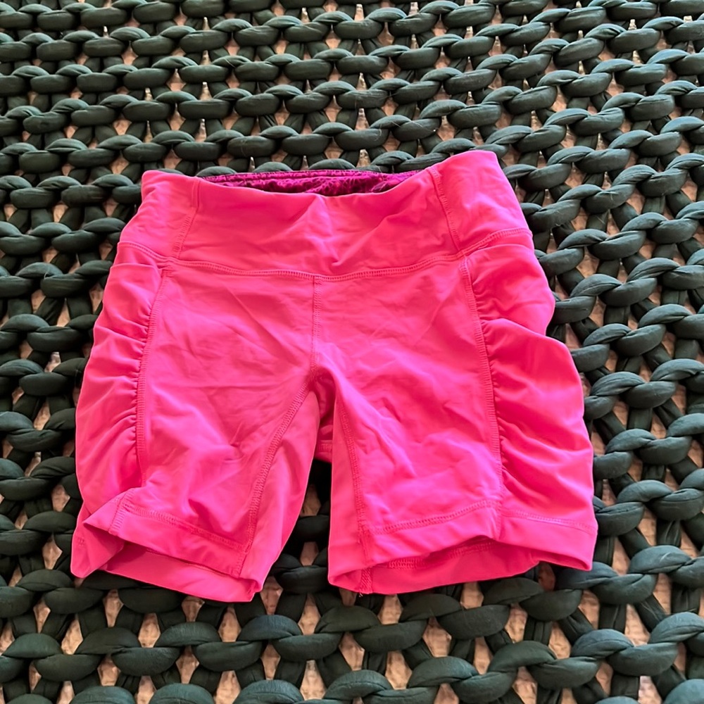 Lululemon speed track shorts in bright pink.